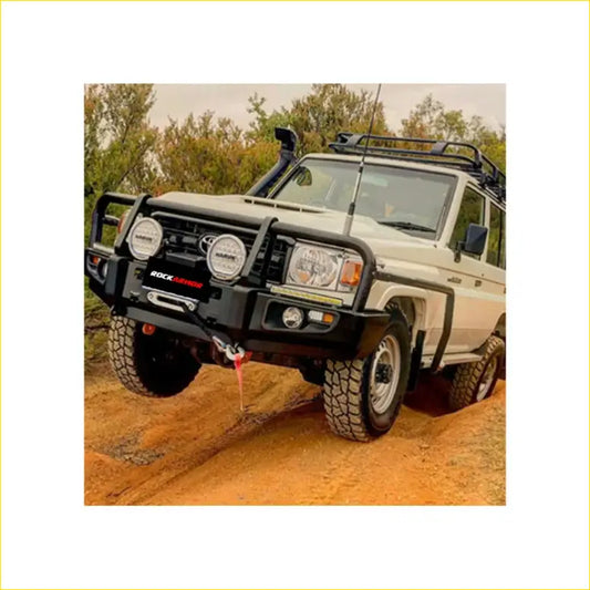 Black rock rock armor front bumper with round headlights and winch hook on white toyota land cruiser ute