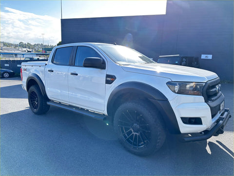 White ford ranger with black wheels and rugged bumper fitted with 4 inch black stainless steel oval running board