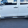 Chrome finished 4 inch oval stainless steel running board with black rubber grip pads on white d max double cab door