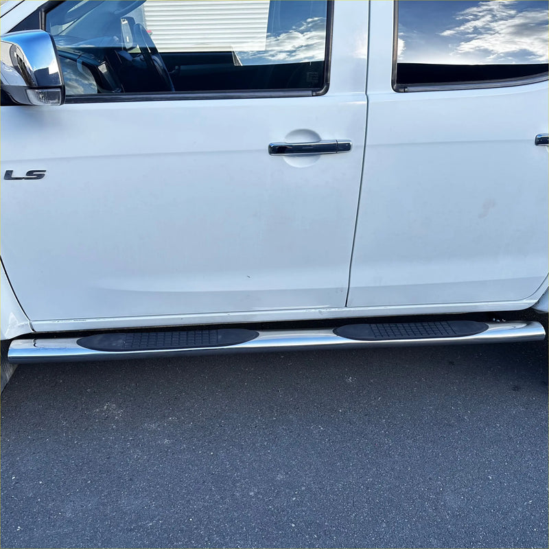 Chrome finished 4 inch oval stainless steel running board with black rubber grip pads on white d max double cab door