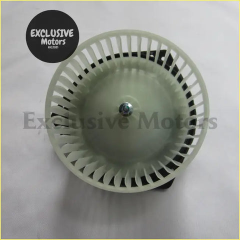 Off-white plastic a/c blower motor for d-max lhd with central metallic bolt and radial slats shown from the back side