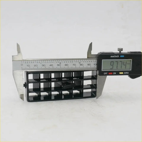 Black plastic rectangular air vent grid for nissan datsun bigm d21 1986-1997 being measured with digital caliper