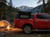 Back view of red nissan navara with aluminium canopy featuring rear view glass and open cargo cover 2015-2025