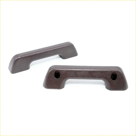 Dark brown plastic armrest handles with textured matte finish and rounded ends for nissan datsun king cab 720 1980-1986