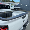 Back view of white nissan navara with black textured bedside rail covers 3 piece set and rubberized tailgate guard
