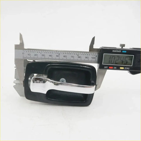 Black plastic door handle bezel with chrome metal pull for Nissan Datsun 620 ute 1972-1979 shown from front side