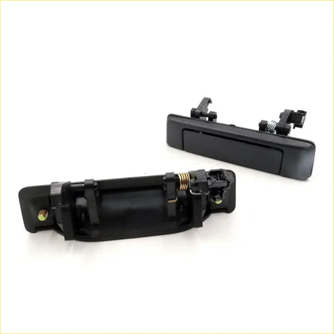 Black plastic outer door handle set for mazda b2000 b2200 b2600 with spring mechanism and mounting hardware back view