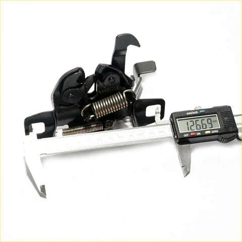 Black metal rear derailleur hanger with integrated spring mechanism shown from the back for Nissan Datsun Navara latch
