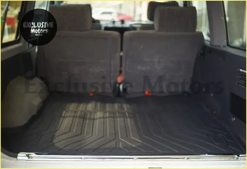 Interior view of nissan patrol y60 boot mat with dark gray rubber geometric pattern and folded rear seats