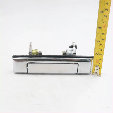 Chrome door handle for toyota hilux 1983-1988 with sleek rectangular design and visible internal spring mechanism back side