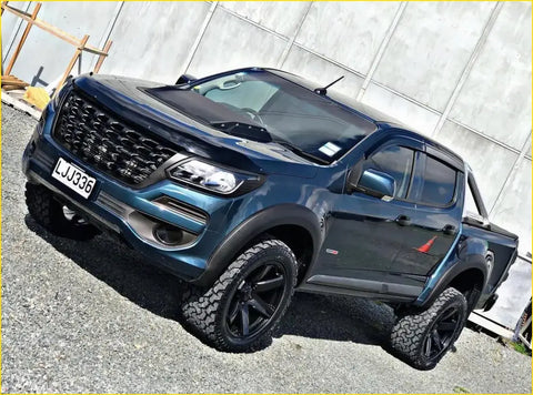 Dark blue metallic colorado pickup truck with black wheels featuring a bonnet guard and visor combo 2017 current model