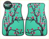 Custom cherry blossom floor mats with teal base and black tree design featuring pink flowers for car interiors
