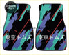 Pair of black custom tokyo toms kanji car floor mats with bold teal purple jagged patterns and red diagonal stripes