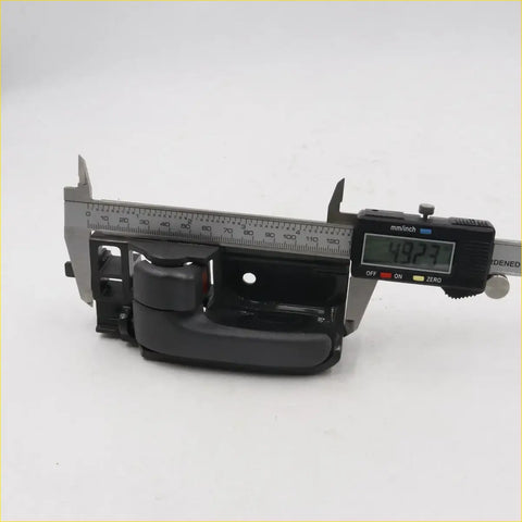 Black plastic door handle bezel for Toyota Hilux SR5 MK6 measured 49.27 mm width with digital caliper