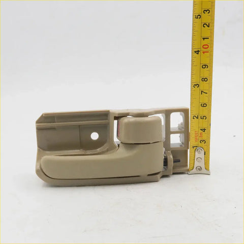 Beige plastic door handle pull with integrated latch for toyota hilux ute sr5 2004-2013 backside view