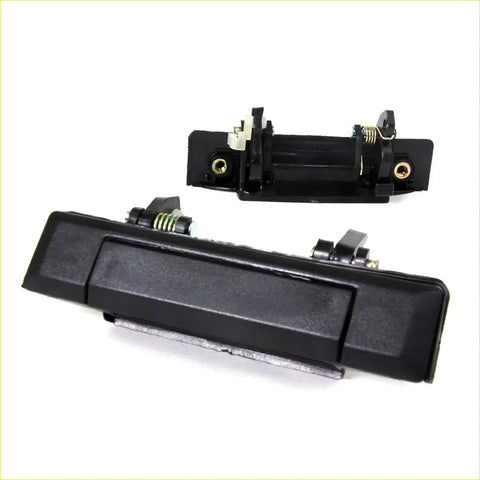 Black plastic door handle with metallic spring and gold mounting screws for toyota hilux mark4 1979-1983 back side