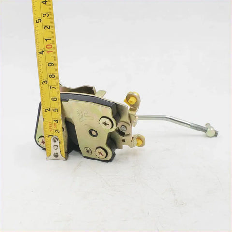Gold-colored metal door lock actuator latch with black rubber padding and yellow screw caps for toyota hilux 1978-1983