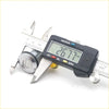 A shiny chrome door lock cylinder for nissan sentra 1995 1999 being measured by a digital caliper