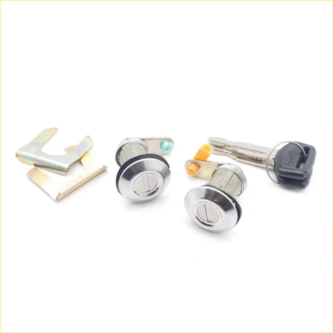 Two shiny chrome door lock cylinders with black seals and keys for toyota hilux 1978-1983