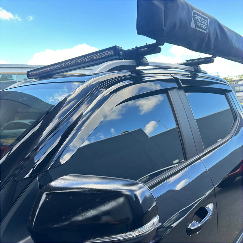 Black ridge ryder rooftop tent on vehicle with led light bar above showing back side of ldv door visors weather shields