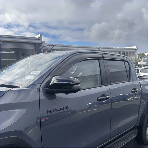 Black plastic door visors window monsoons weather shields installed on dark gray toyota hilux 2015-current