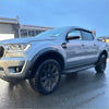 Silver ford ranger px3 2019-2021 with smooth 4-inch fender flare black wheels and side steps shown from back side