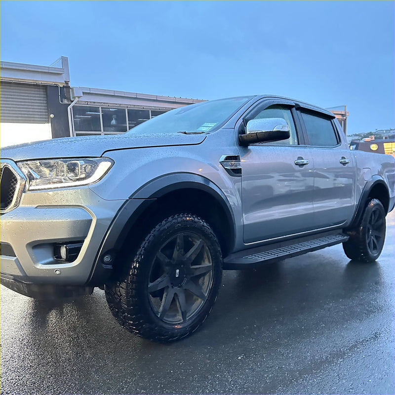 Silver ford ranger px3 2019-2021 with smooth 4-inch fender flare black wheels and side steps shown from back side