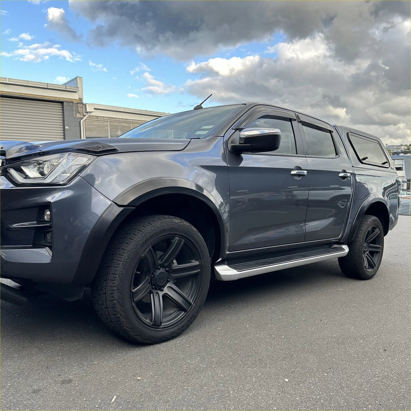 Dark gray metallic isuzu d-max 2021-2023 with matte black 4-inch smooth style fender flares and black alloy wheels