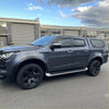 Dark gray metallic isuzu d-max 2021-2023 with matte black 4-inch smooth style fender flares and black alloy wheels back view