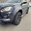 Dark gray isuzu d-max 2021-2023 with matte black 4-inch smooth style fender flares black alloy wheels and side steps