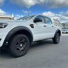 White ford ranger px3 with textured black oem style fender flares and rugged off-road tires