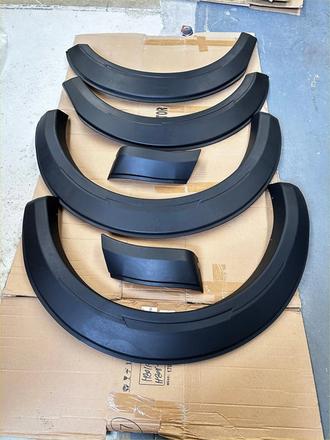 Black plastic matte black smooth style fender flares for gwm cannon 2019 plus arranged on cardboard in pairs