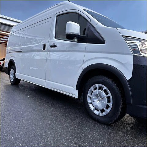 White nissan nv350 with silver alloy wheels featuring smooth black fender flare for hiace 19 plus new shape zx minibus