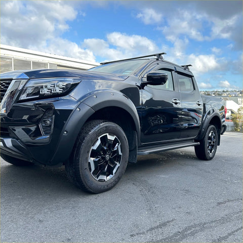Black nissan navara 2021+ with matte black bolt style fender flare and black silver alloy wheels side view