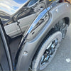 Black matte-finish bolt style fender flare for nissan navara 2021 with integrated fuel door trim shown from back side