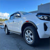 White isuzu d-max with chrome accents and alloy wheels featuring matte black fender flare nissan navara 2021+ style
