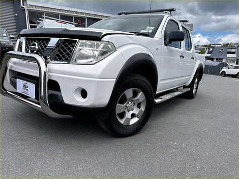White nissan navara d40 pickup with matte black smooth style fender flares chrome bull bar and black side steps