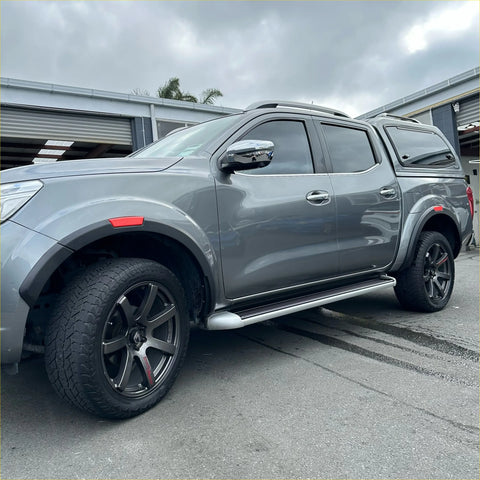 Gray metallic nissan navara pickup with black alloy wheels and roof rack featuring red layer fender flare np300 2015-2020