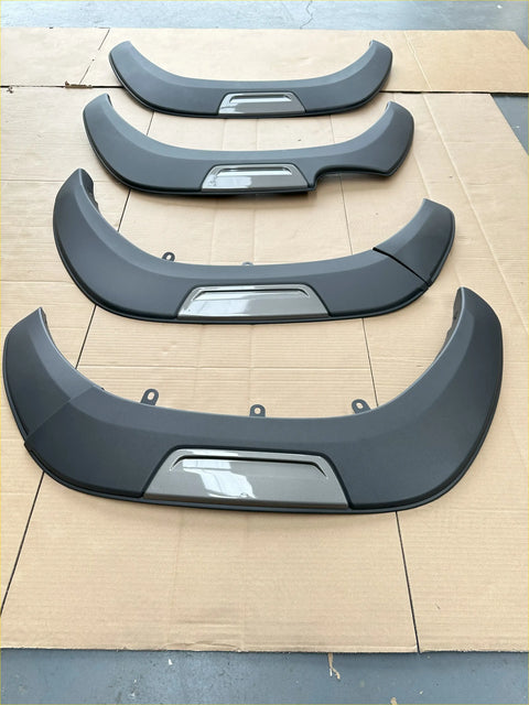 Black plastic fender flares with glossy finish and silver accents for toyota hilux 2021-2024 sr sr5 oem style