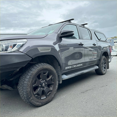 Dark gray toyota hilux sr5 cruiser pickup with black wheels featuring fender flare oem style gray layer for 2021-2024 models