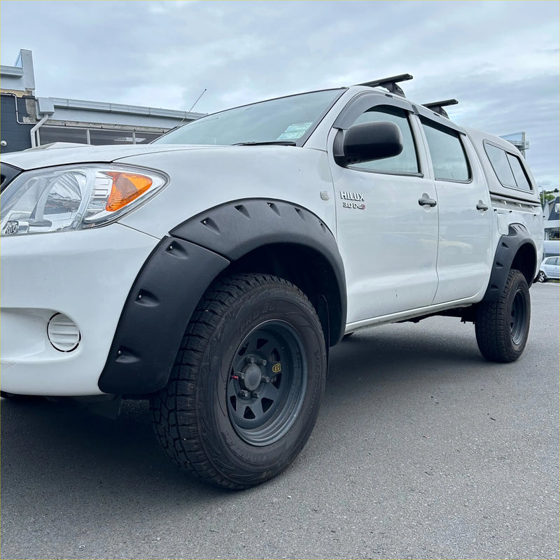 White toyota hilux pickup with black textured bolt style fender flares and rugged tires for 2005-2012 vigo models