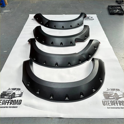 Black matte textured metal fender flares with rugged angular design and mounting holes for toyota hilux vigo 2012-2015