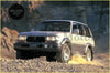 Silver and black toyota land cruiser with rugged tires and bold front bumper radiator grille for off-road use
