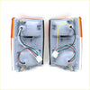 Pair of gray plastic front turn signal lights for isuzu elf 5th gen with orange lens accents and multi-colored wiring
