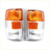 A pair of clear and orange plastic front turn signal lights with textured lenses for isuzu elf 5th gen and gmc