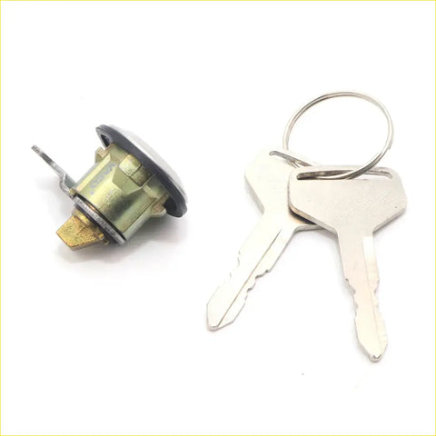Silver fuel tank gas filler lock cylinder with black rubber top and brass mechanism plus two keys for nissan d21 navara
