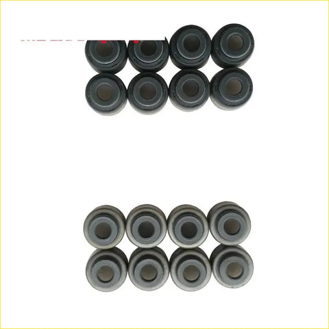 Black rubber and metallic gray valve stem oil seal bushings arranged in two rows for toyota tercel gasket pro set