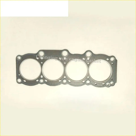 Black engine head gasket with four circular openings and textured surface for toyota celica 3sg e 3s-ge engines