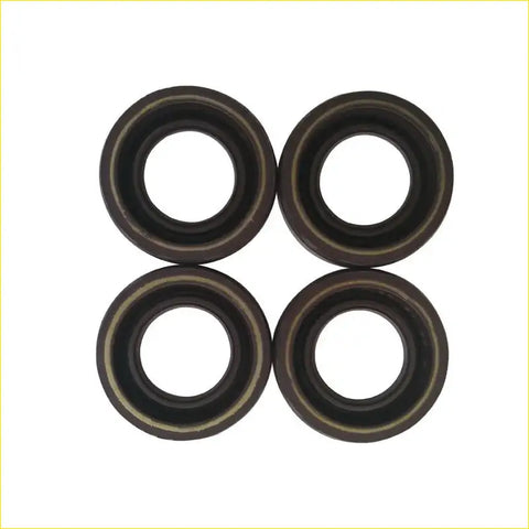 Four black rubber spark plug gaskets with metallic inner rings arranged in a square for toyota carina 7afe