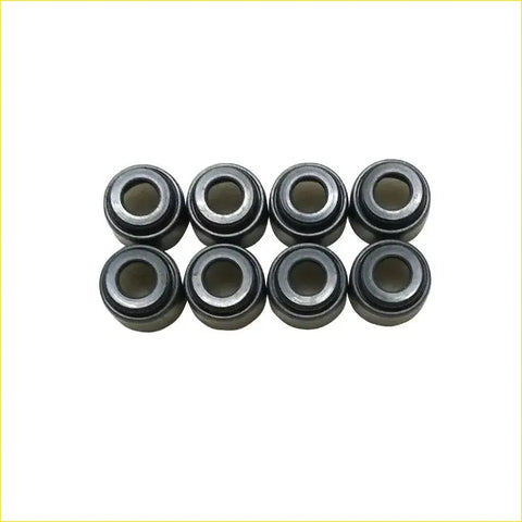 Eight black metal valve stem oil seal bearing cups arranged in two rows for gasket pro cd20 nissan sunny y10